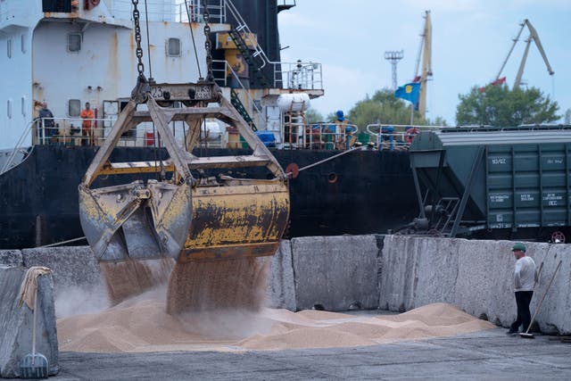 Workers load grain at a grain port in Izmail, Ukraine, under the Black Sea Grain Initiative (Andrew Kravchenko/AP/PA)
