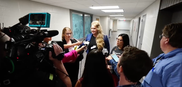 <p>Wisconsin teacher Melissa Tempel and her attorney speak with reporters on 12 July, 2023, after the educator was fired for criticising a district decision not to let children sing a Miley Cyrus song about rainbows.</p>