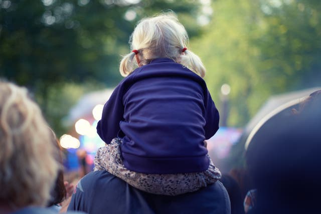 <p>Best seat in the house: A little girl sits atop her dad’s shoulders at a music festival </p>