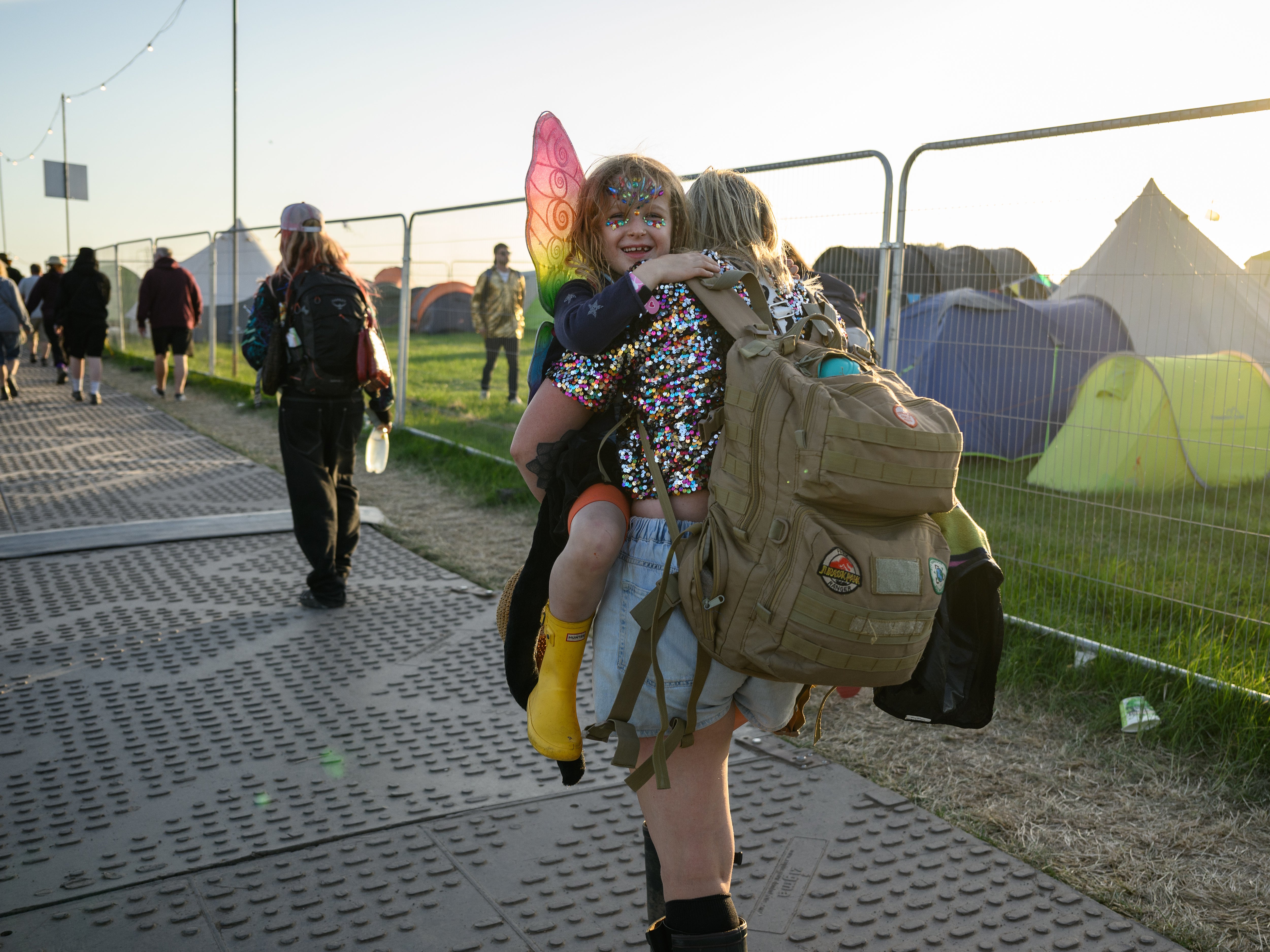 A young girl is carried out of Glastonbury Festival in 2022