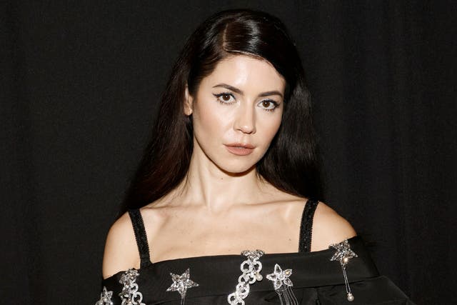 <p>Marina of Marina and the Diamonds poses backstage for the Christian Siriano SS2022 Fashion Show at Gotham Hall on September 07, 2021</p>