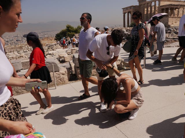 <p>A visitor is affected by the heat atop the Acropolis hill, during a heatwave in Athens, Greece, July 14, 2023</p>