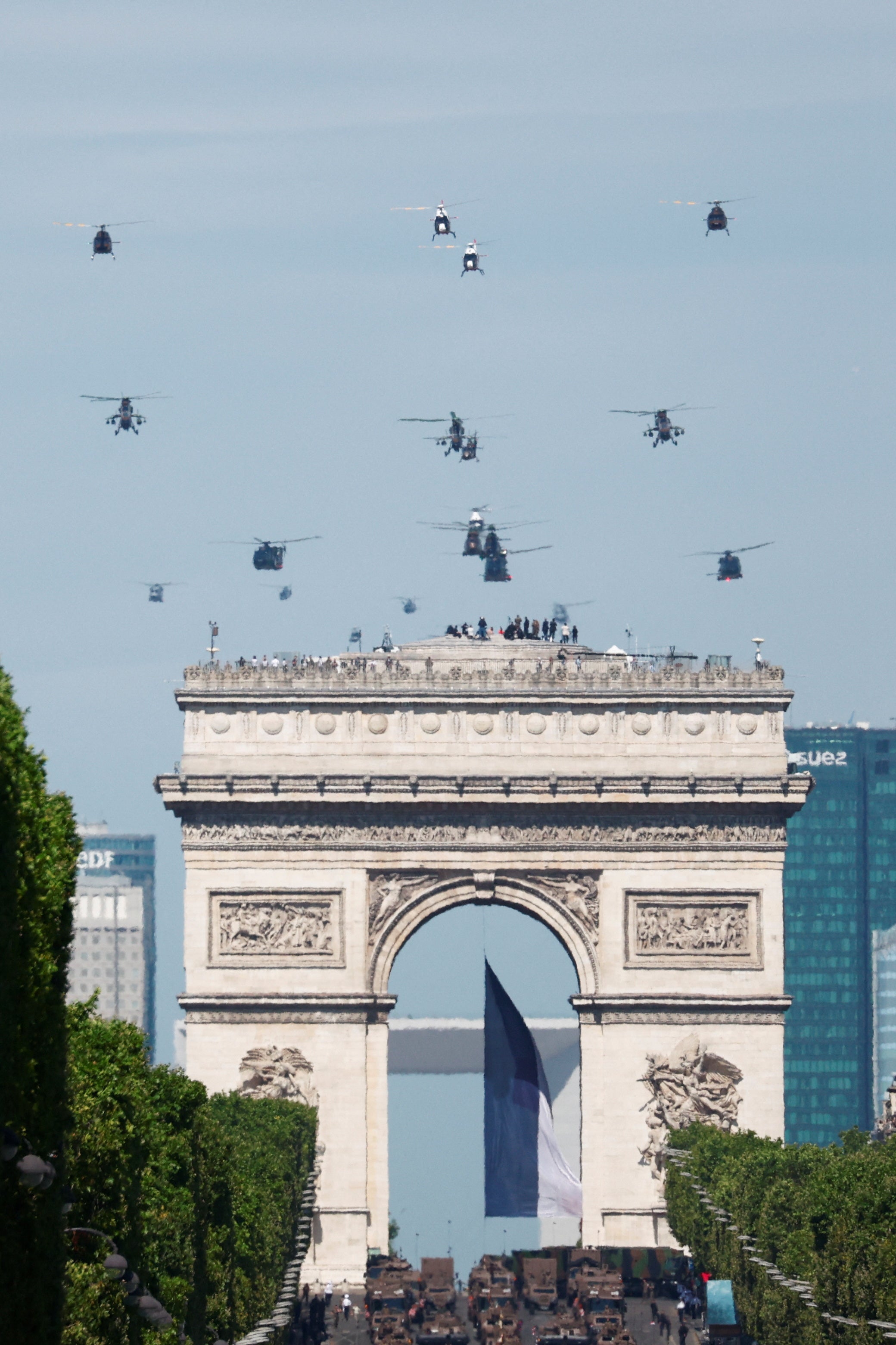 Helicopters fly over the Champs-Elysees Avenue during the annual Bastille Day military parade in Paris.