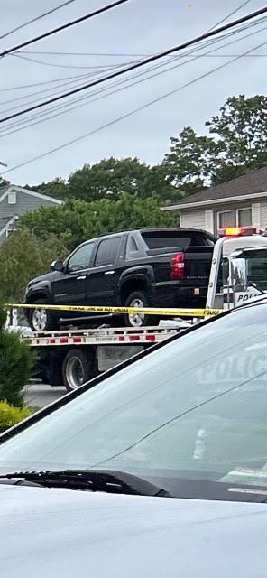 Police removed a pickup truck from the Massapequa Park street where Rex Heuermann was arrested on Friday