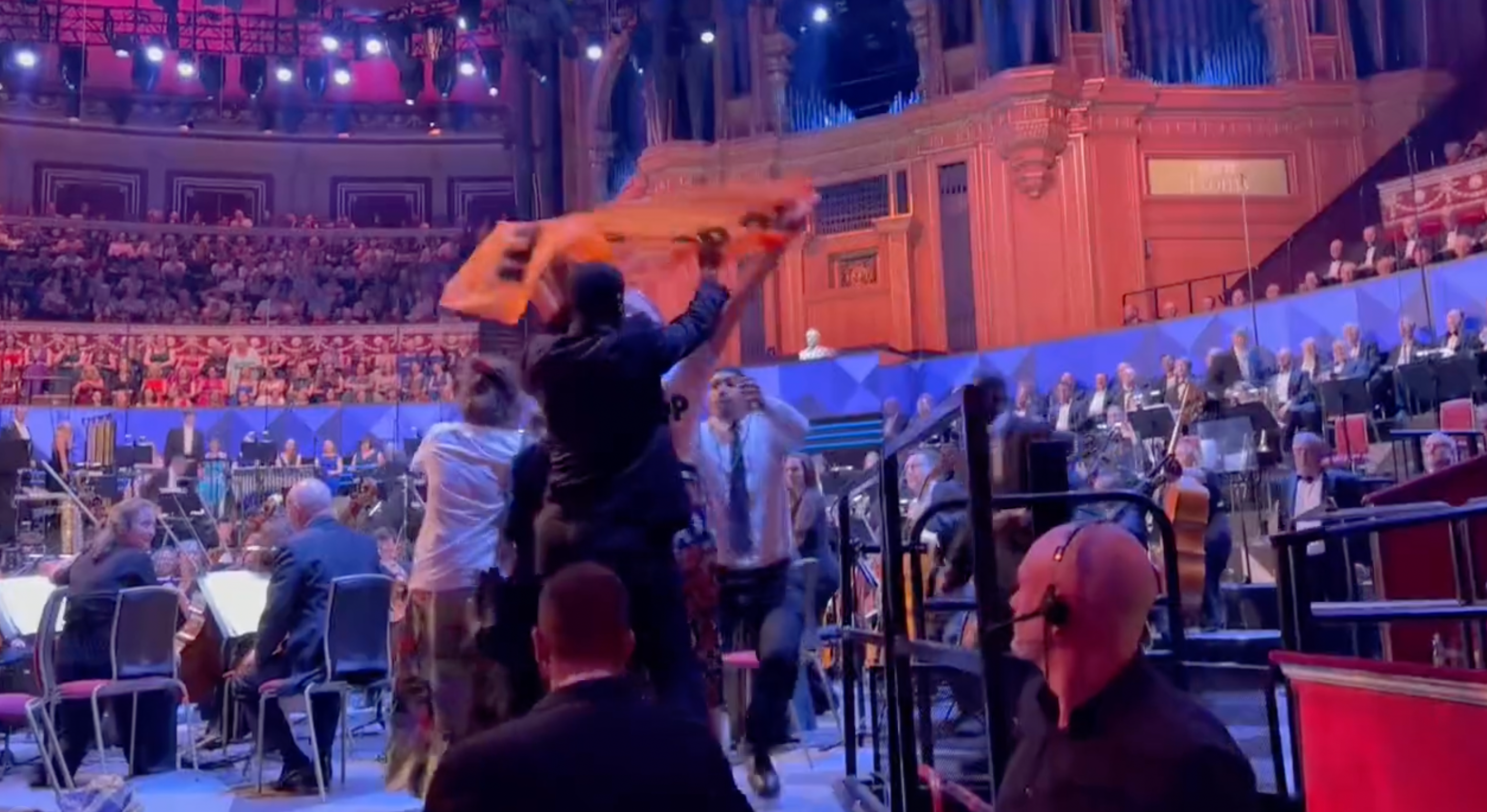 Security staff were seen removing the campaigners from the BBC Proms stage at the Royal Albert Hall on Friday