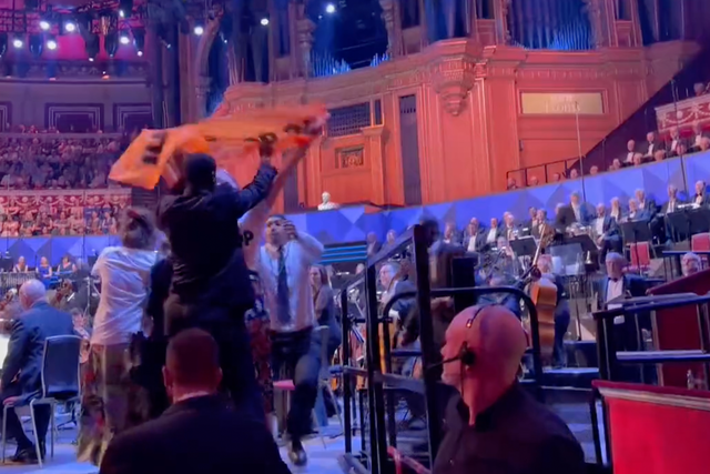 <p>Security staff were seen removing the campaigners from the BBC Proms stage at the Royal Albert Hall on Friday</p>