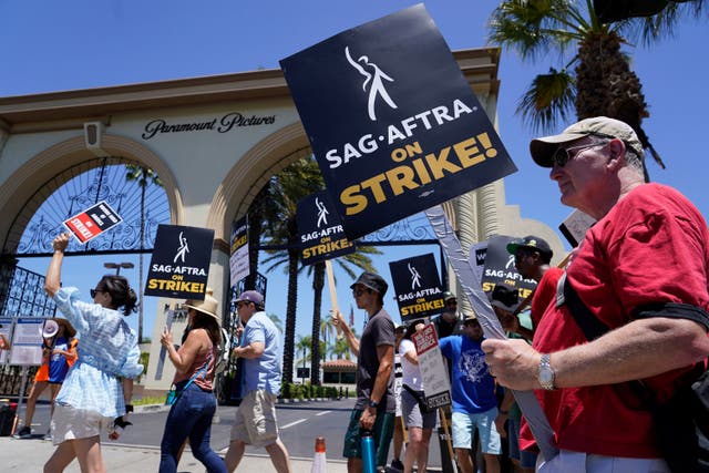 Striking writers and actors picket outside Paramount studios in Los Angeles on Friday (Chris Pizzello, AP)