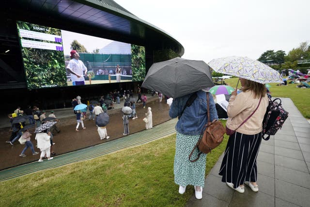 Spectators with umbrellas are expected to be a common sight at Wimbledon on Saturday (Andrew Matthews/PA)