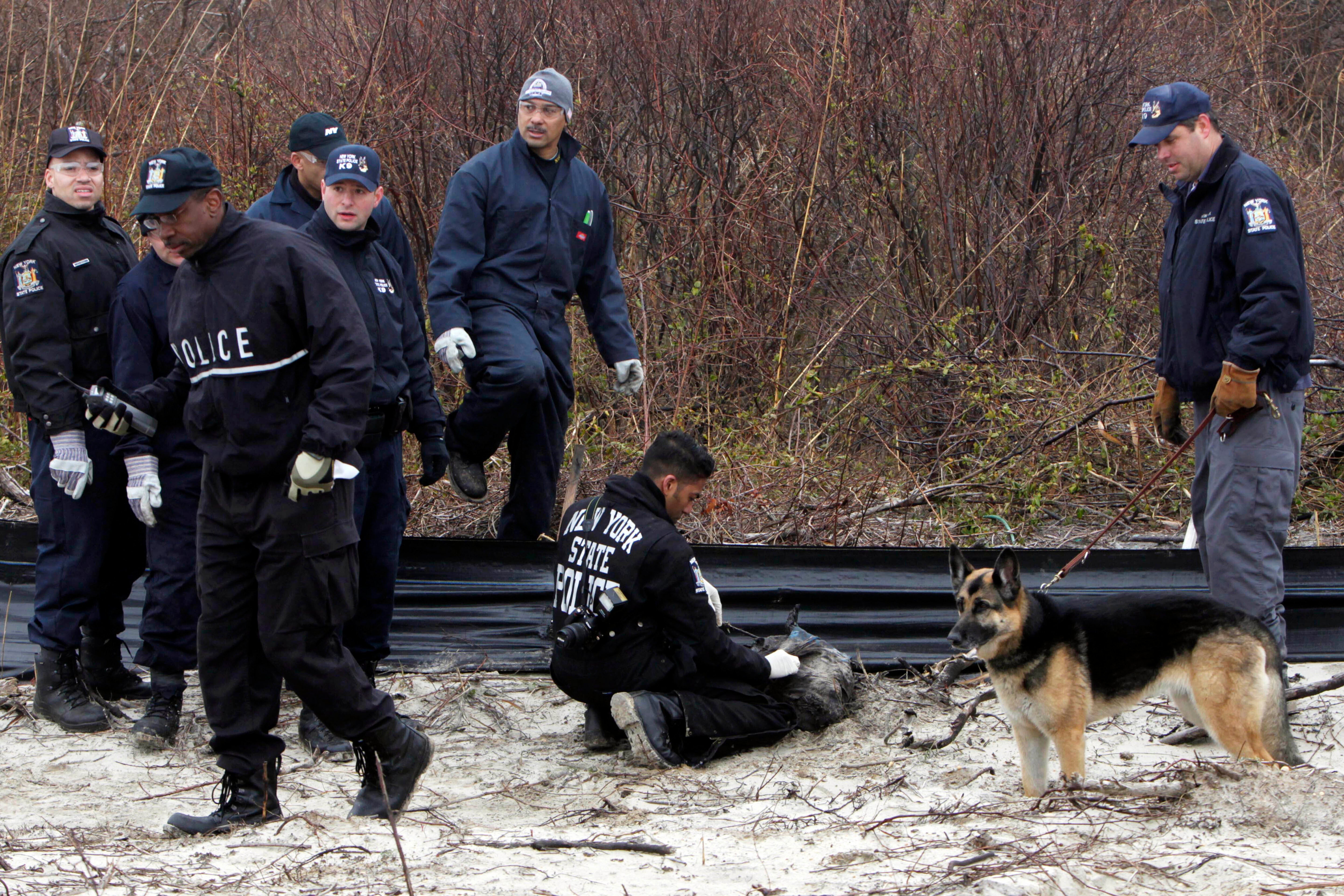 Investigators are seen searching the shores of Gilgo Beach in 2011