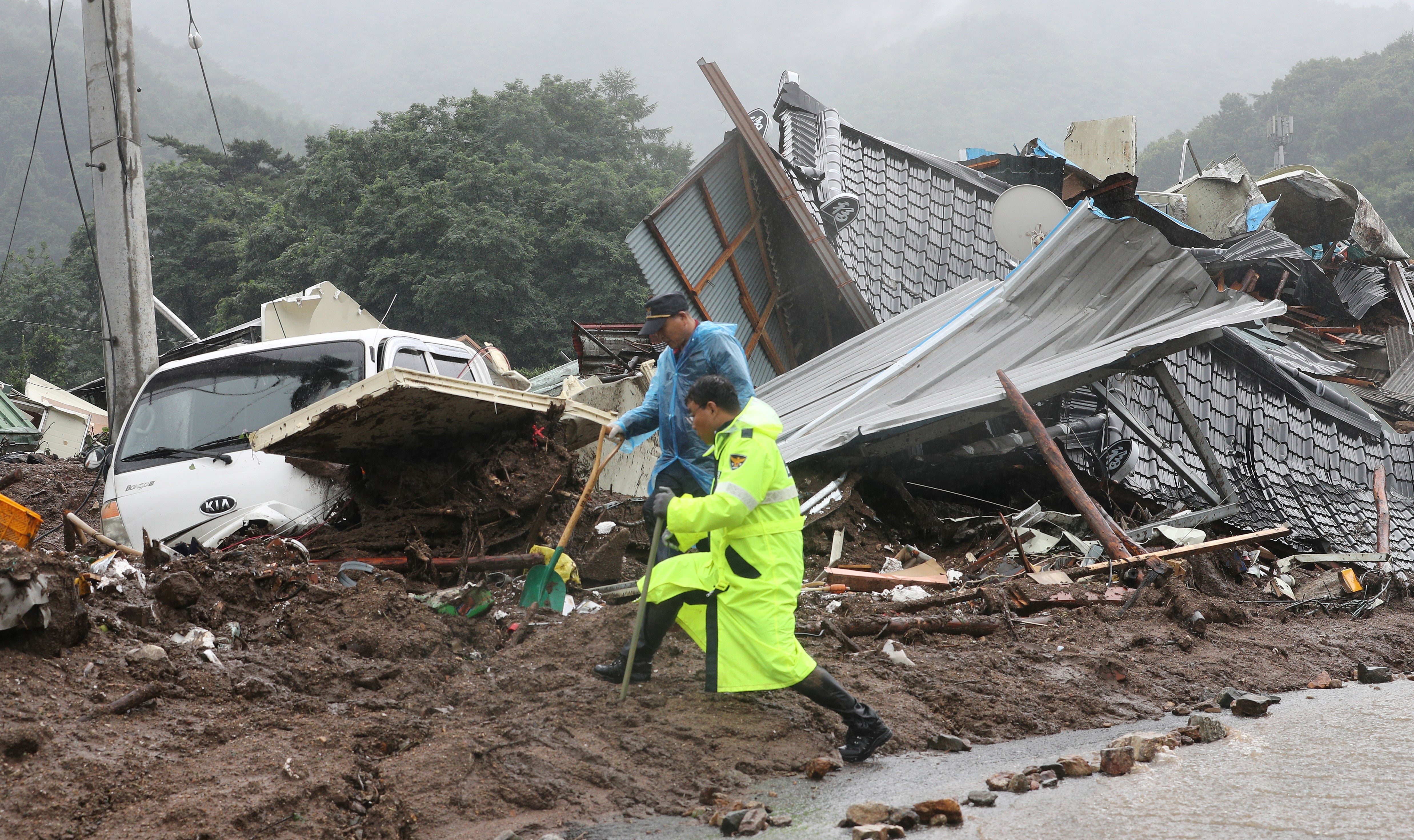<p>South Korean emergency workers search for survivors after a landslide hit a small village in Yecheon </p>