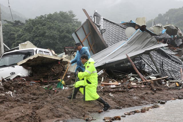 <p>South Korean emergency workers search for survivors after a landslide hit a small village in Yecheon </p>