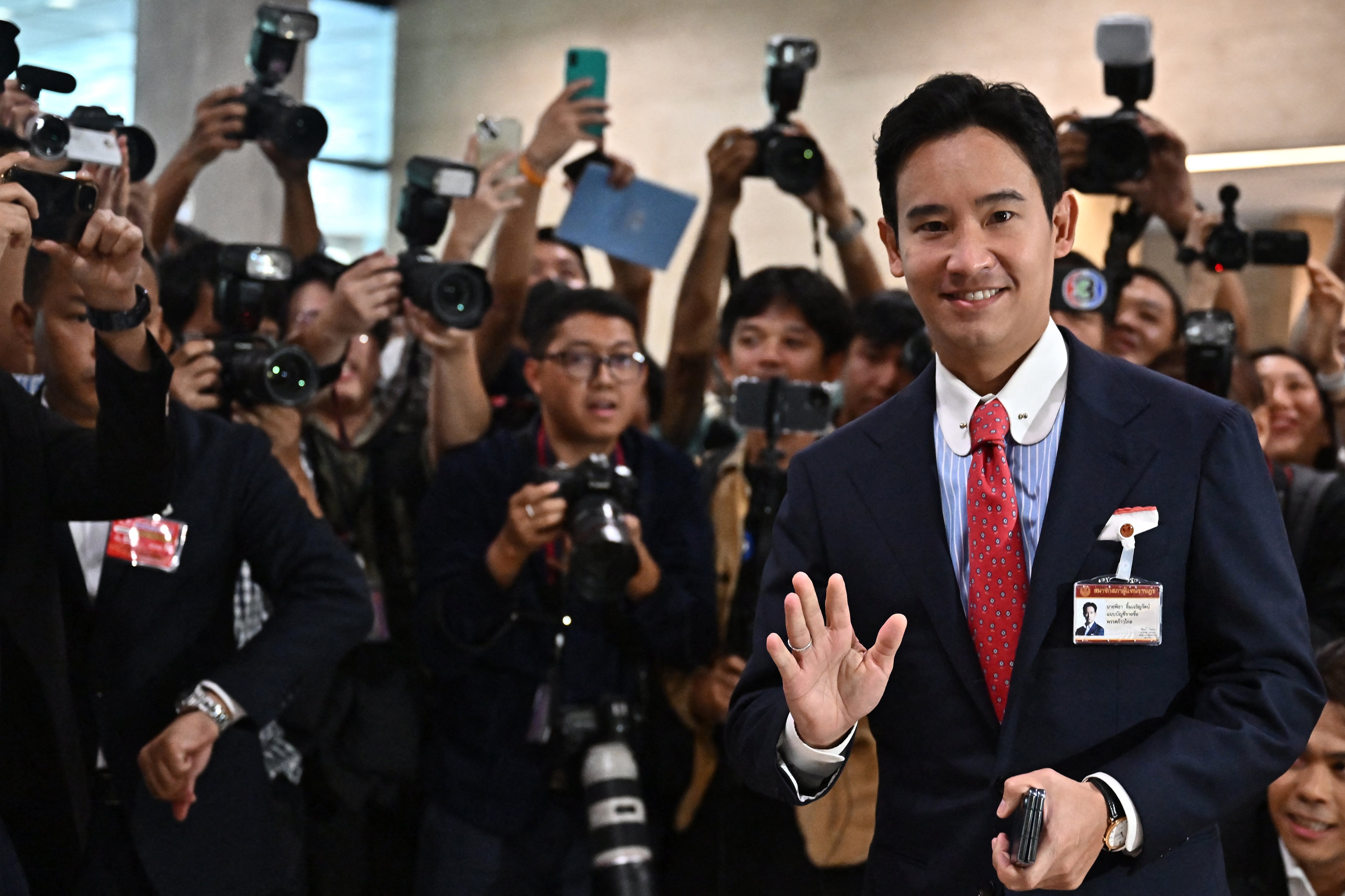 Move Forward Party Leader and prime minister candidate Pita Limjaroenrat gestures as he arrives at the Thai Parliament