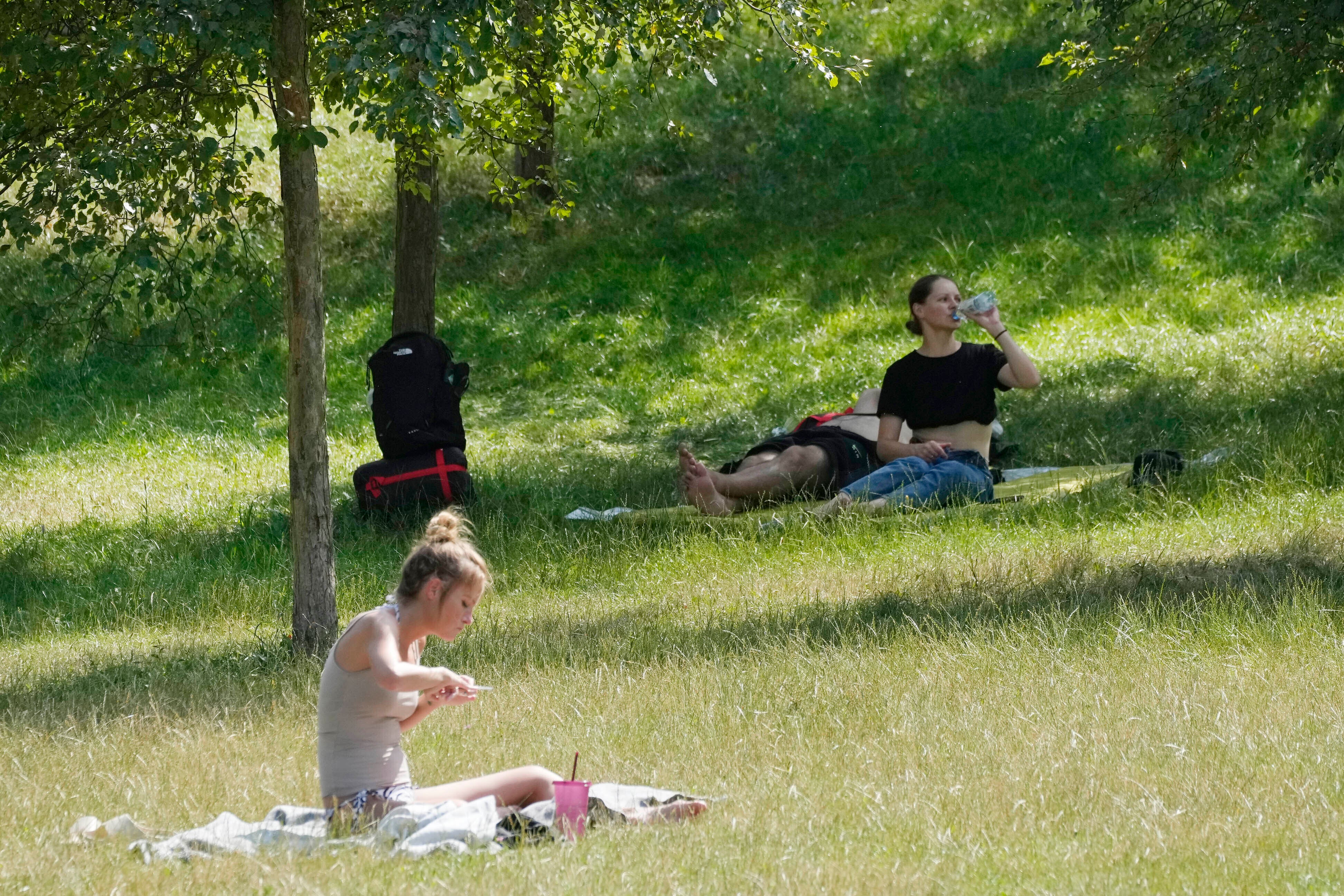 <p>People rest in a park in Warsaw, Poland, on Saturday, July 15.  </p>