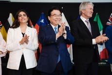 Britain officially joins an Asia-Pacific trade group that includes Japan and 10 other nations