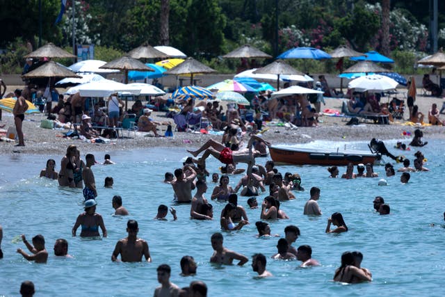 Swimmers enjoy the sea in Athens, Greece, amid the heatwave (Yorgos Karahalis/AP)