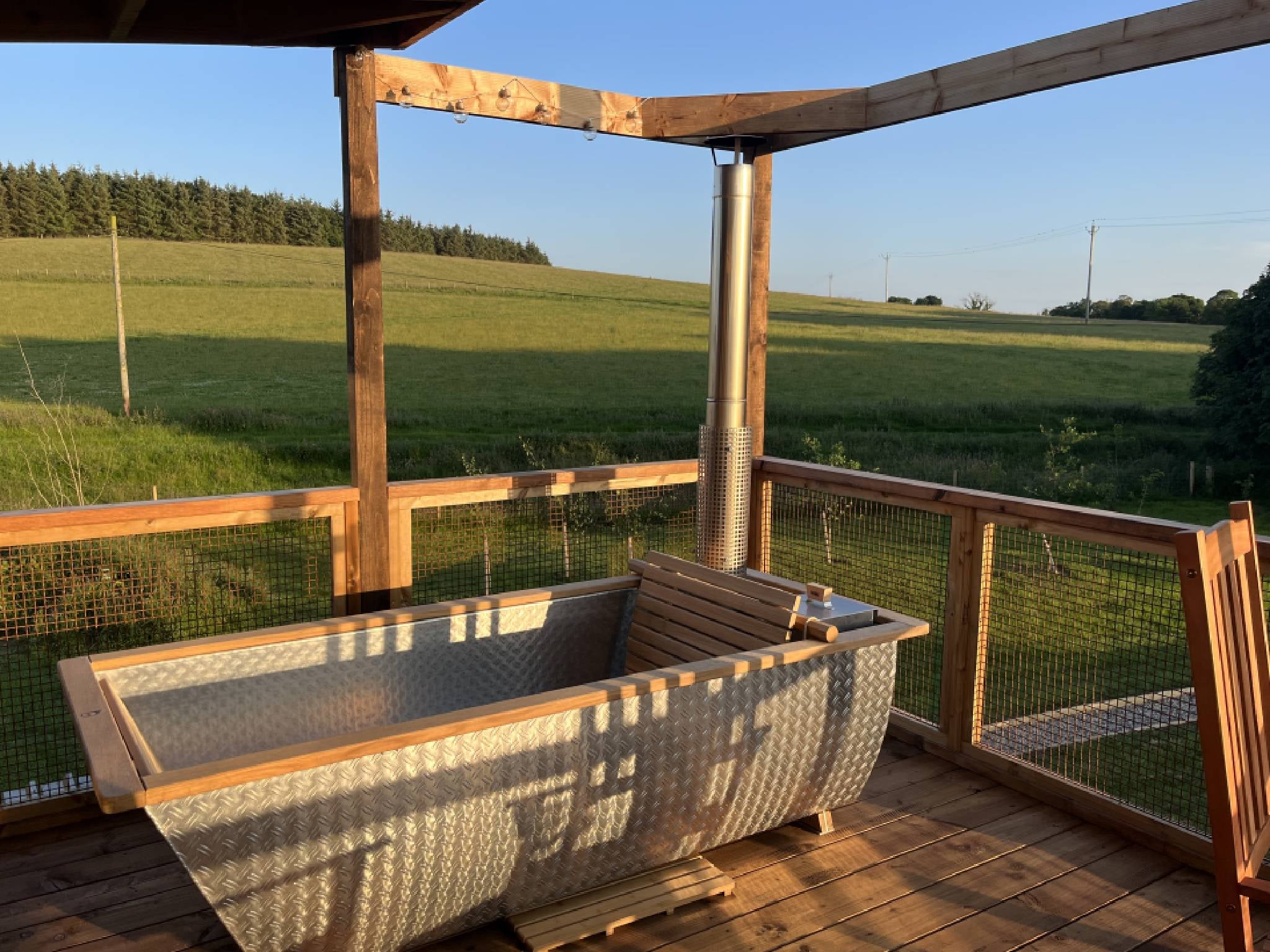 The wood fired bath is perfectly positioned for taking a sunset dip