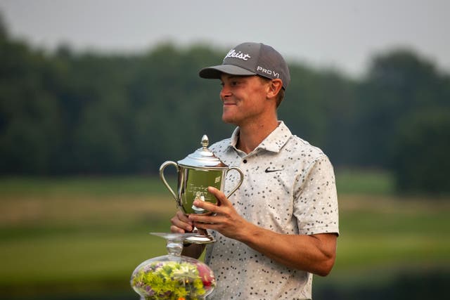 Vincent Norrman holds a trophy after winning the Barbasol Championship golf tournament at Keene Trace Golf Club (Ryan C Hermens/Lexington Herald-Leader via AP)