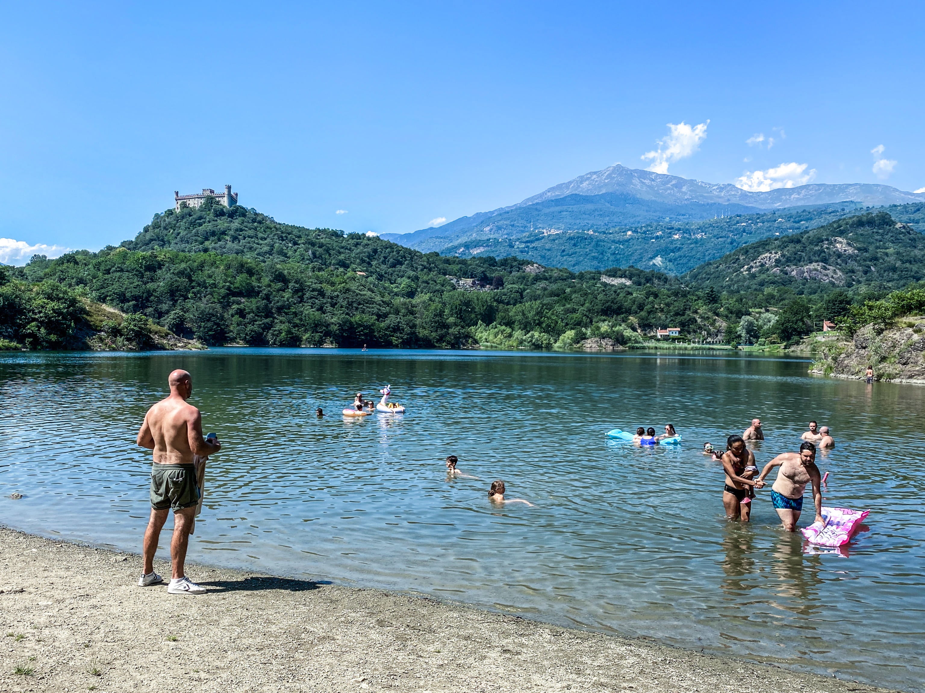 <p>People bathe in the area of Lake Sirio to cool off, in the province of Turin, Italy</p>