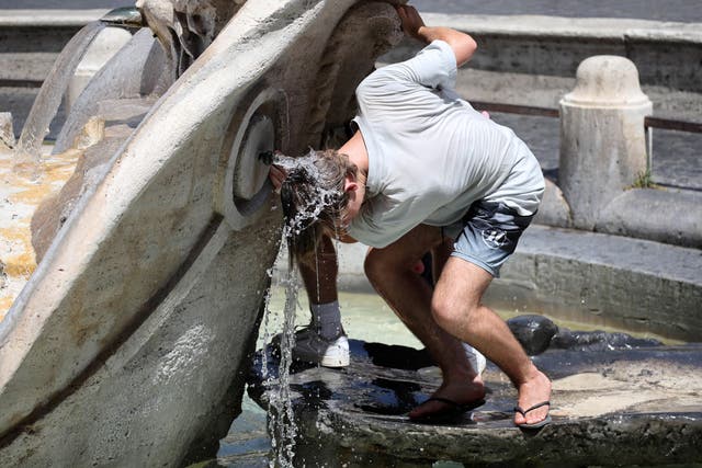 <p>A man cools off in a fountain during a heat wave in Rome, Italy</p>