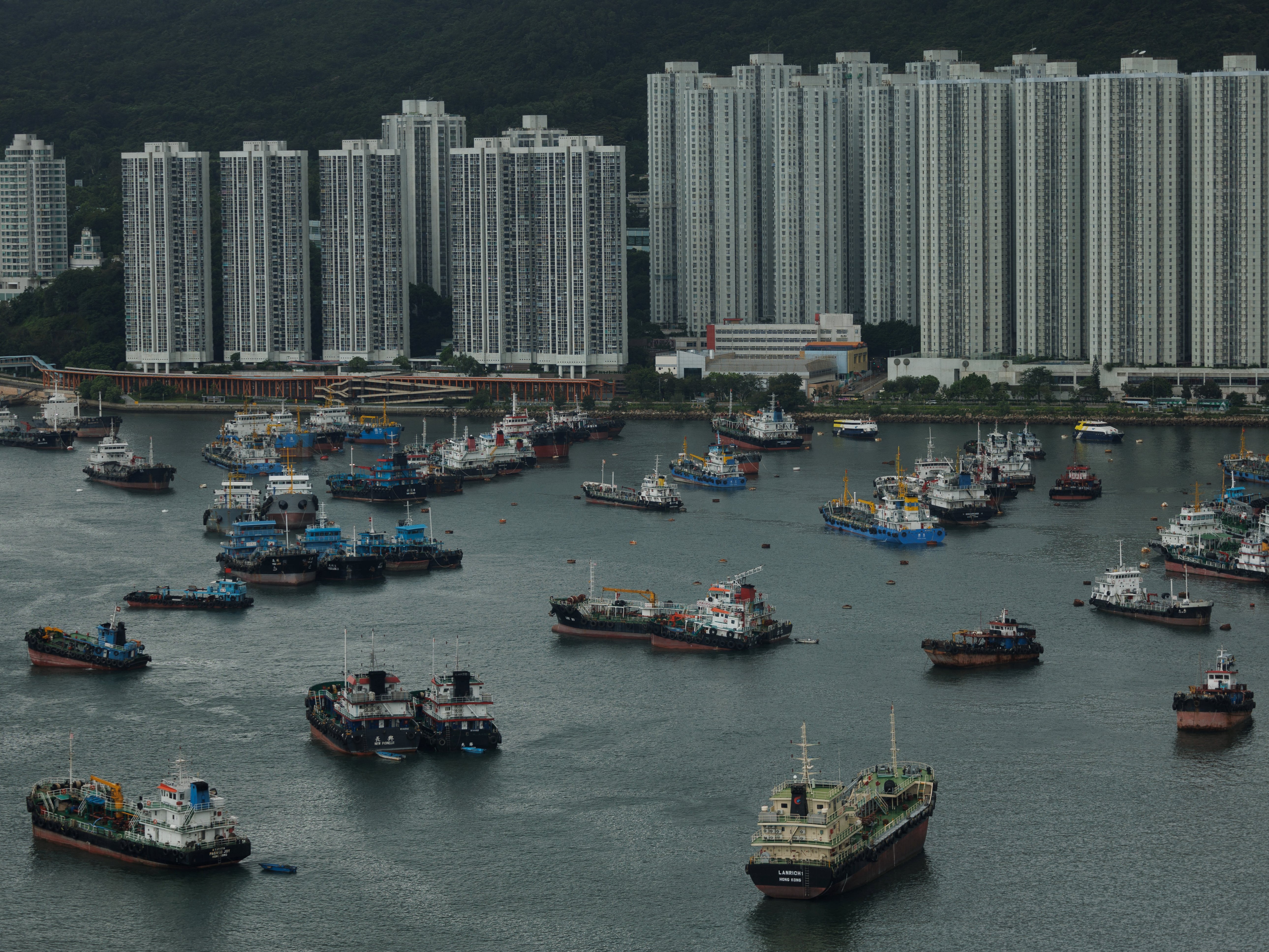 Boats are parked at a typhoon shelter in Tseun Wan as a precaution for the approaching Typhoon Talim in Hong Kong on 16 July 2023