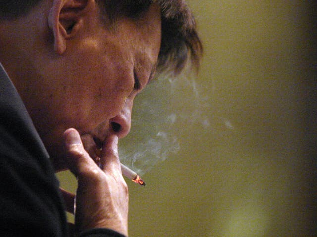 <p>Representational image: A man smokes a cigarette in Hong Kong</p>