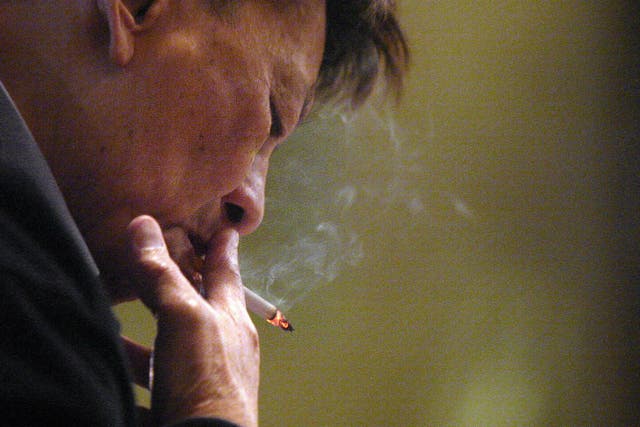 <p>Representational image: A man smokes a cigarette in Hong Kong</p>