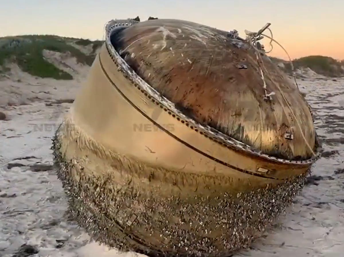 Mysterious giant cylinder washes up on Australian beach as officials urge public to stay away