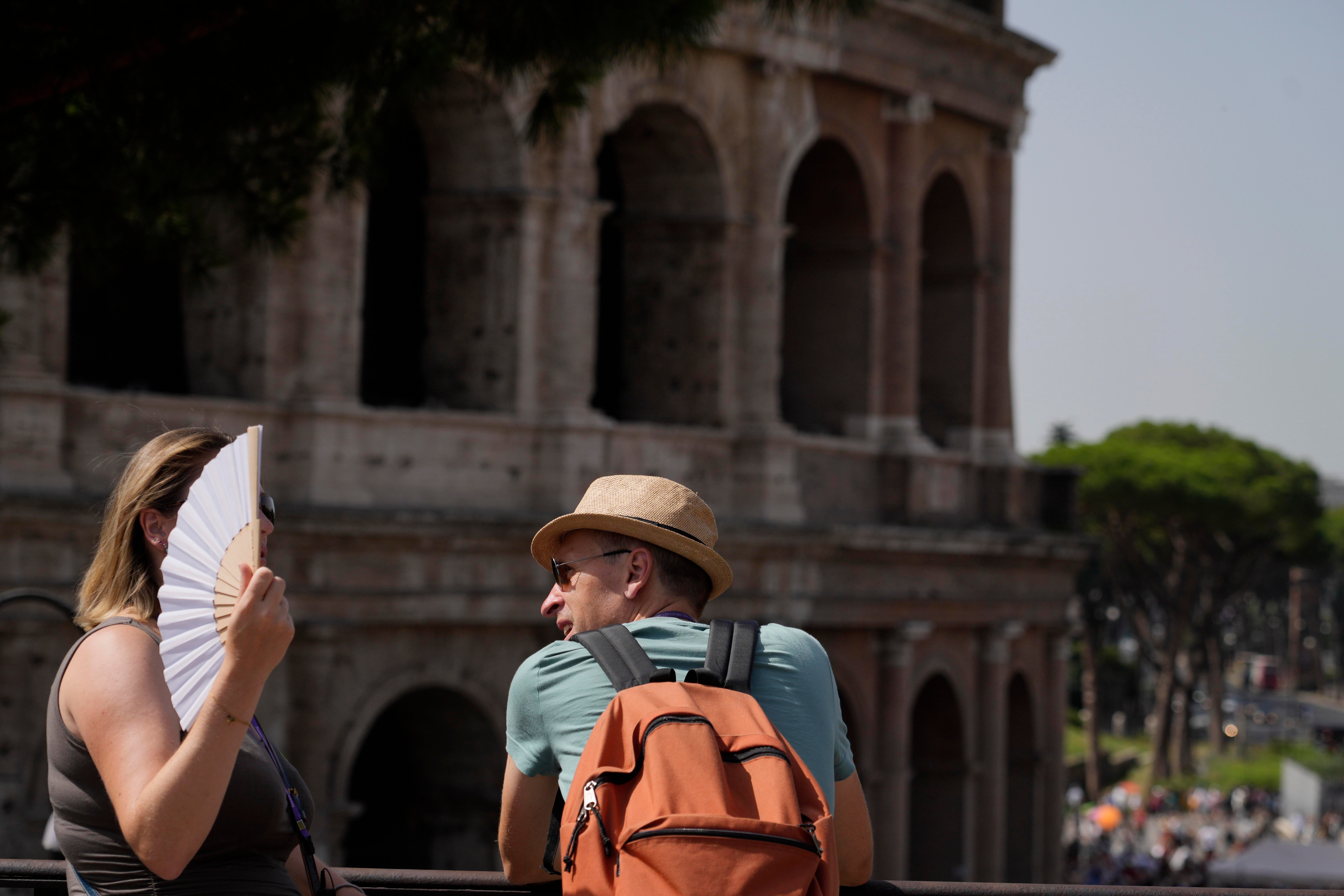 Tourists stops in front of the Colosseum in Rome