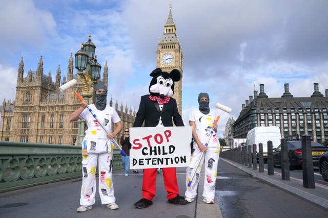 Dom Joly, dressed as Mickey Mouse, leads the protest (Lucy North/PA)