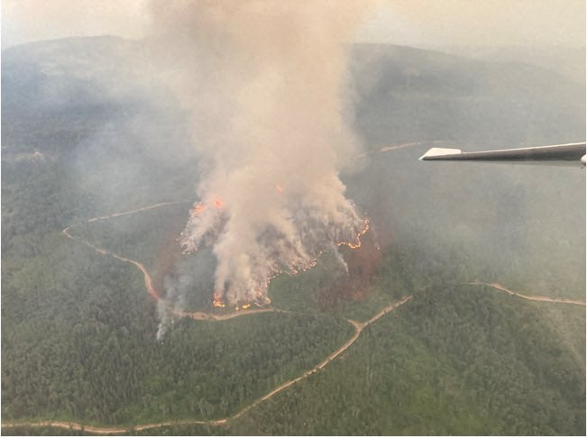 <p>An aerial view of the Powers Creek wildfire, just south of Smithers, British Columbia, Canada. Winds are pushing wildfire smoke south into the US again this week</p>