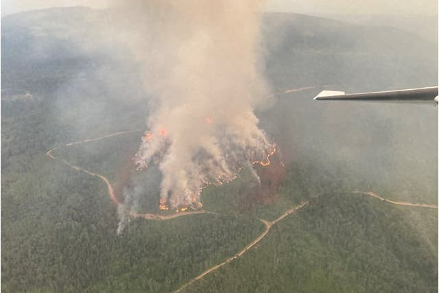 <p>An aerial view of the Powers Creek wildfire, just south of Smithers, British Columbia, Canada. Winds are pushing wildfire smoke south into the US again this week</p>