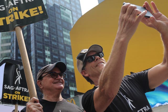 <p>Kevin Bacon (R) and SAG-AFTRA members and supporters protest as the SAG-AFTRA Actors Union Strike continues in front of Paramount Studios at 1515 Broadway on July 17, 2023 in New York City. </p>