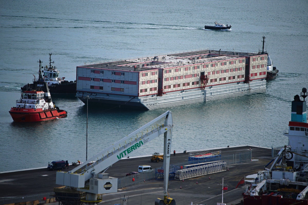 Bibby Stockholm migrant barge docks in Dorset as protesters gather at quayside