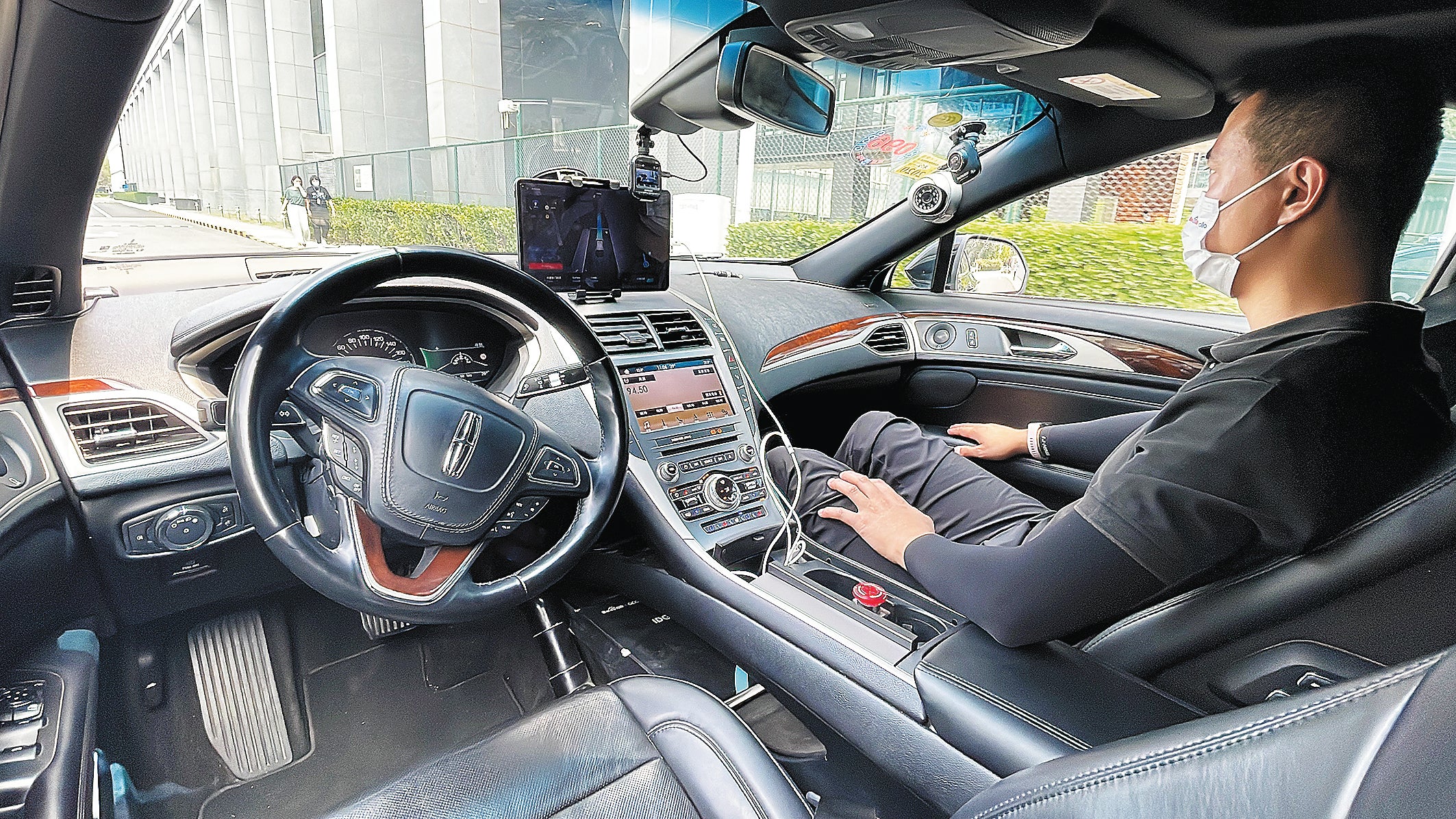 A passenger travels in a driverless car at Baidu Technology Park in Beijing