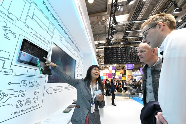 <p>Visitors learn about the intelligent solutions at the booth of COSMOPlat, an industrial internet platform under home appliance manufacturer Haier Group, during the Hannover Messe in Hannover, Germany </p>