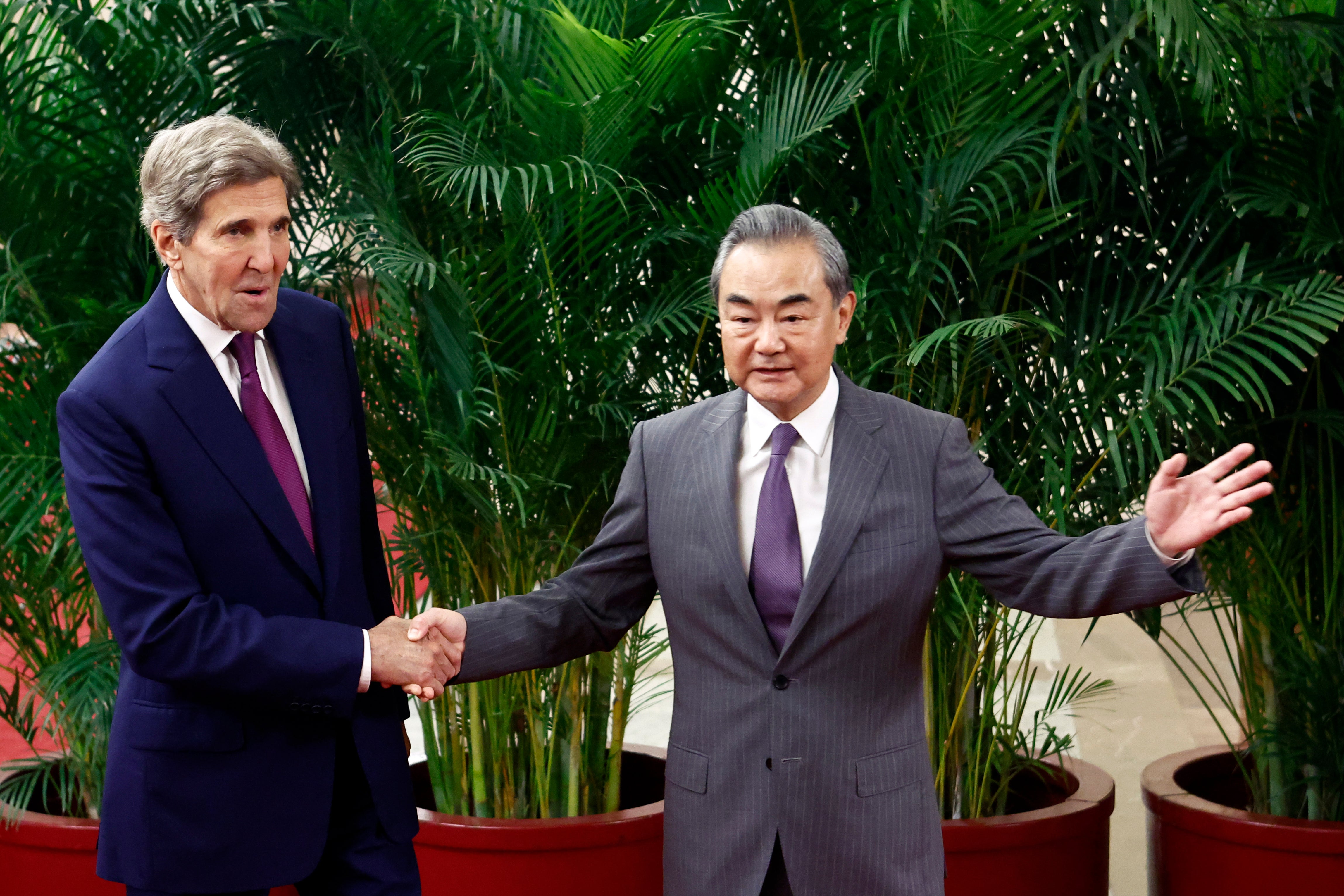 US climate envoy John Kerry (L) is greeted by top Chinese diplomat Wang Yi