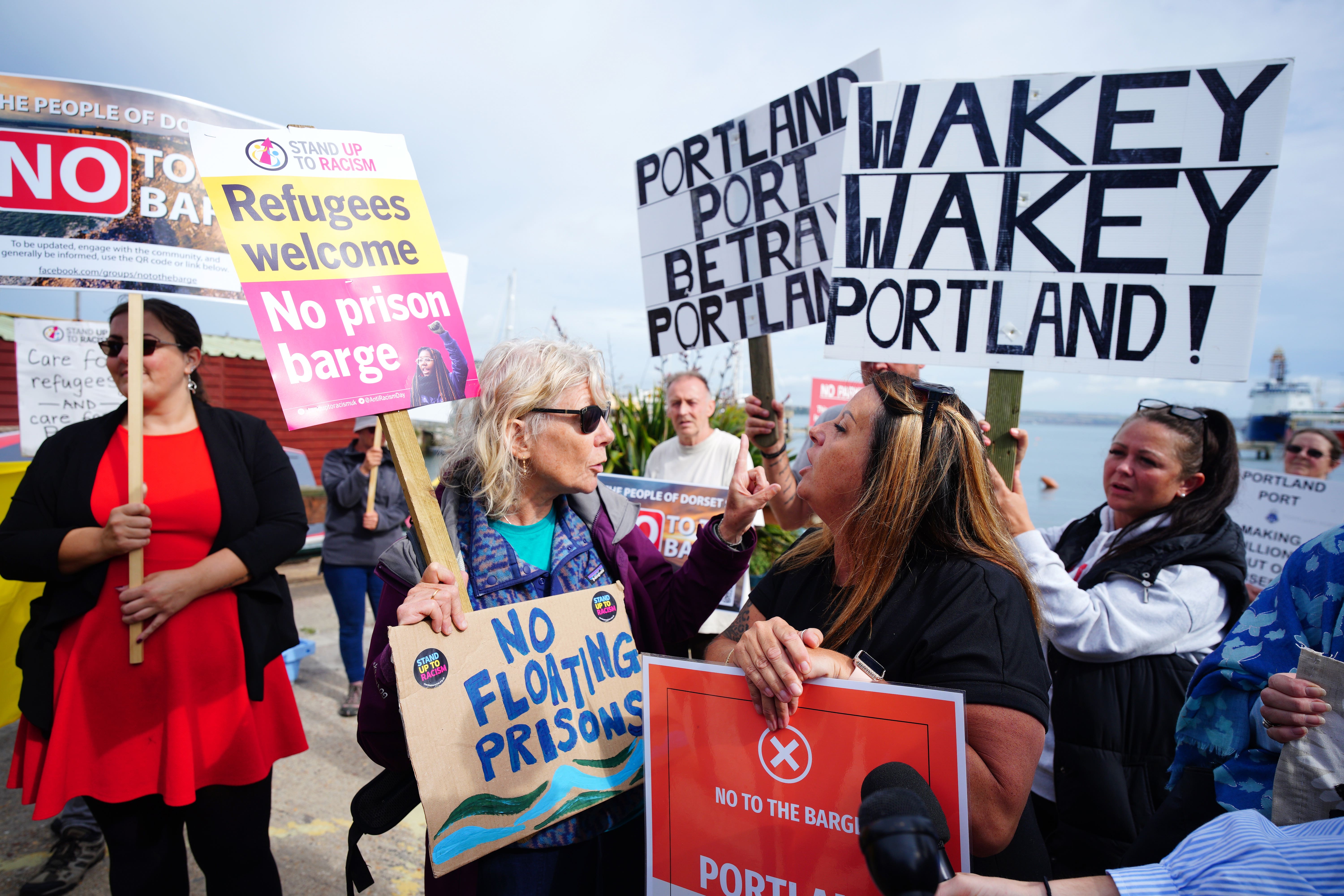 Rival protesters argue in Portland in Dorset after the Bibby Stockholm barge arrived last month (Ben Birchall/PA)
