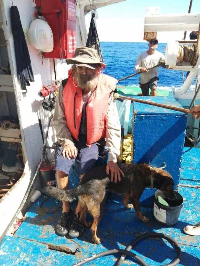 <p>Tim Shaddock sits with his dog Bella after being rescued by a Mexican tuna boat</p>