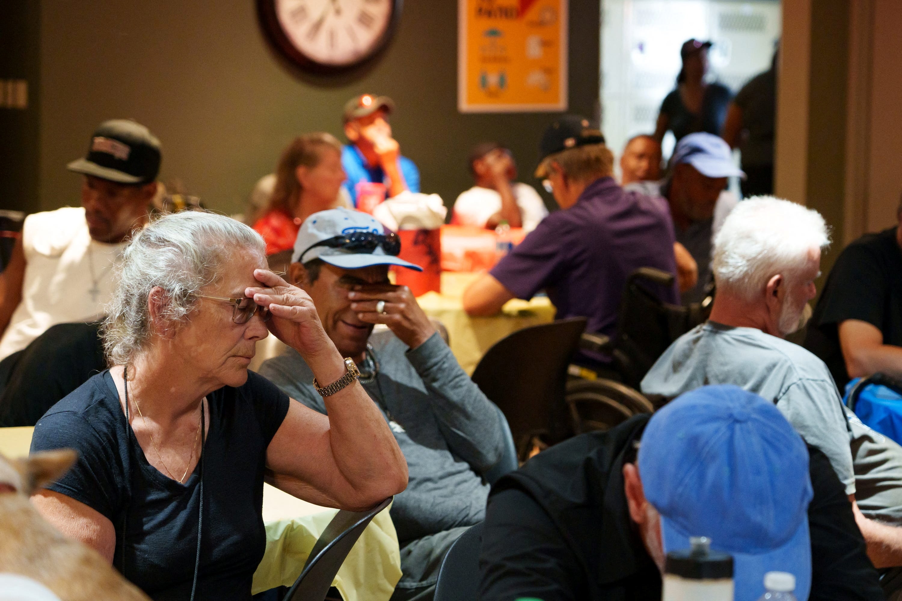 People sit in a crowded room at Justa Center, one of the Valley’s many cooling centers, during a heat wave in Phoenix, Arizona on Sunday