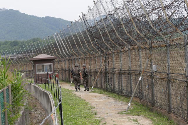 <p>File photo: South Korean soldiers patrol while hikers visit the DMZ Peace Trail in the demilitarized zone in Goseong, South Korea, June 14, 2019.</p>