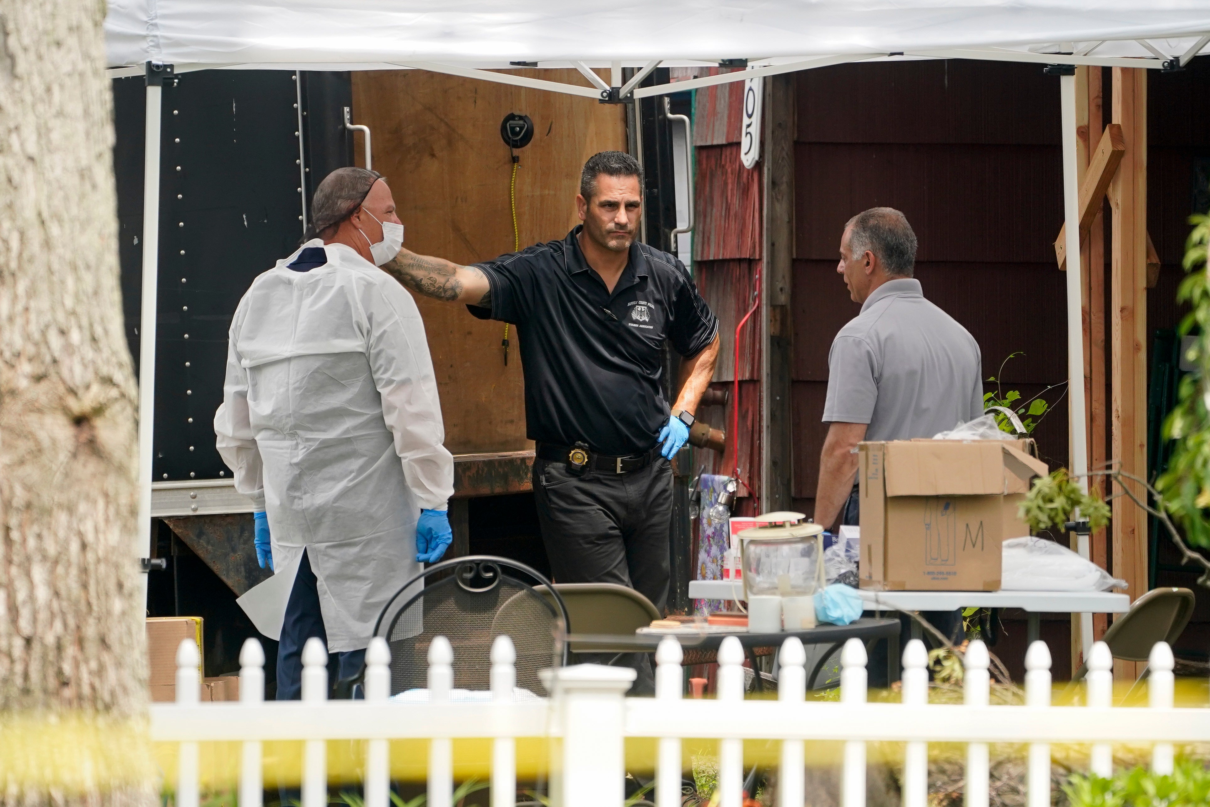Authorities work outside as they search the home of suspect Rex Heuermann, Tuesday, July 18, 2023, in Massapequa Park, NY