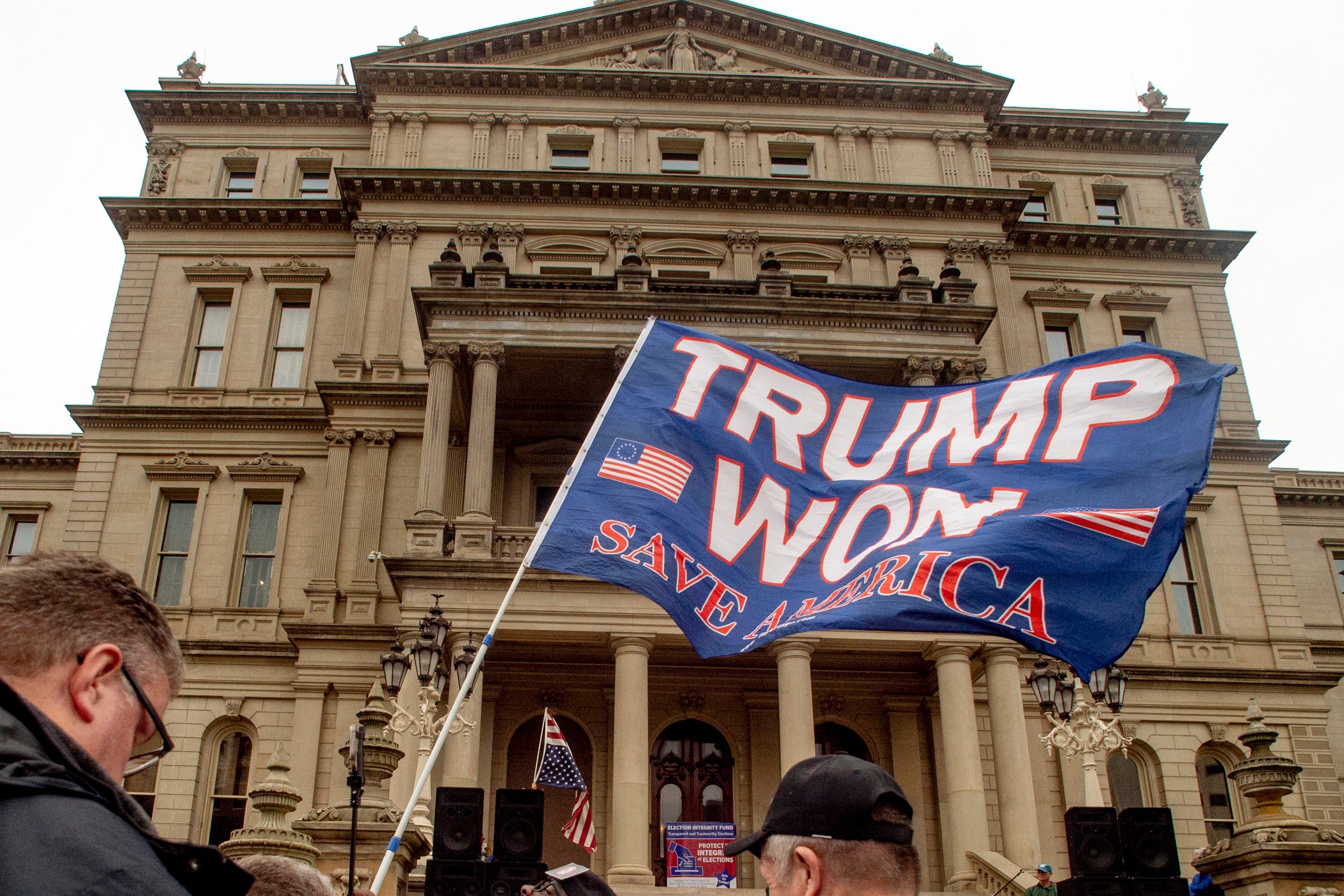 A protester outside the Michigan State Capitol in Lansing waves a ‘Trump Won’ flag on 12 October, 2021.