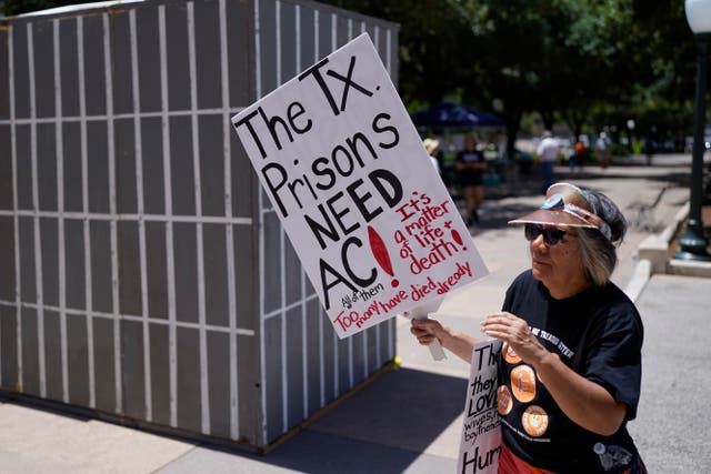<p>An advocate for cooling Texas prisons walks past a makeshift cell during a rally on the steps of the Texas Capitol, Tuesday, July 18, 2023, in Austin, Texas</p>