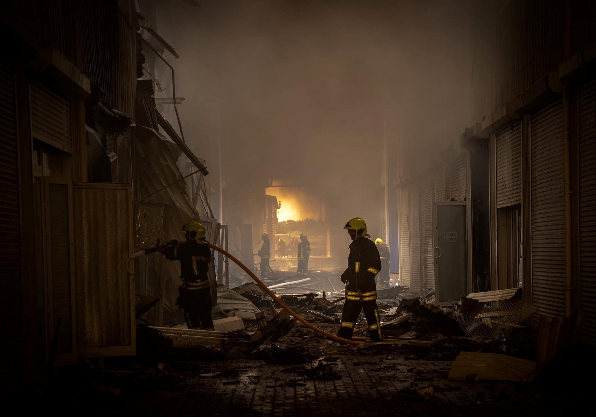 Firefighters at the site of one of the strikes in Odesa
