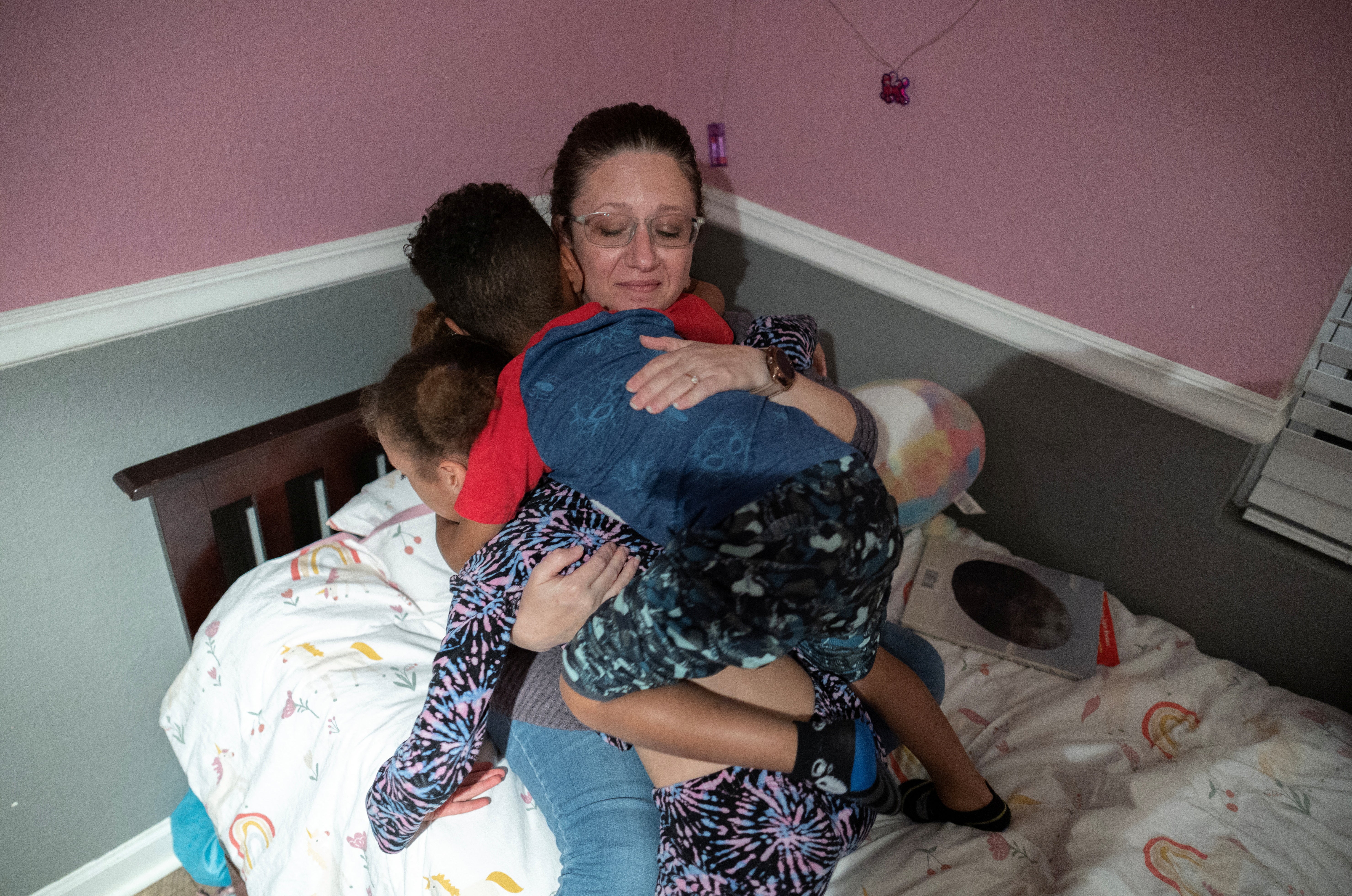 Gallegos hugs her children as she puts them to bed at her home the night before she leaves for Carbondale, Illinois, to spend several days running the Alamo Women’s Clinic, in San Antonio, Texas