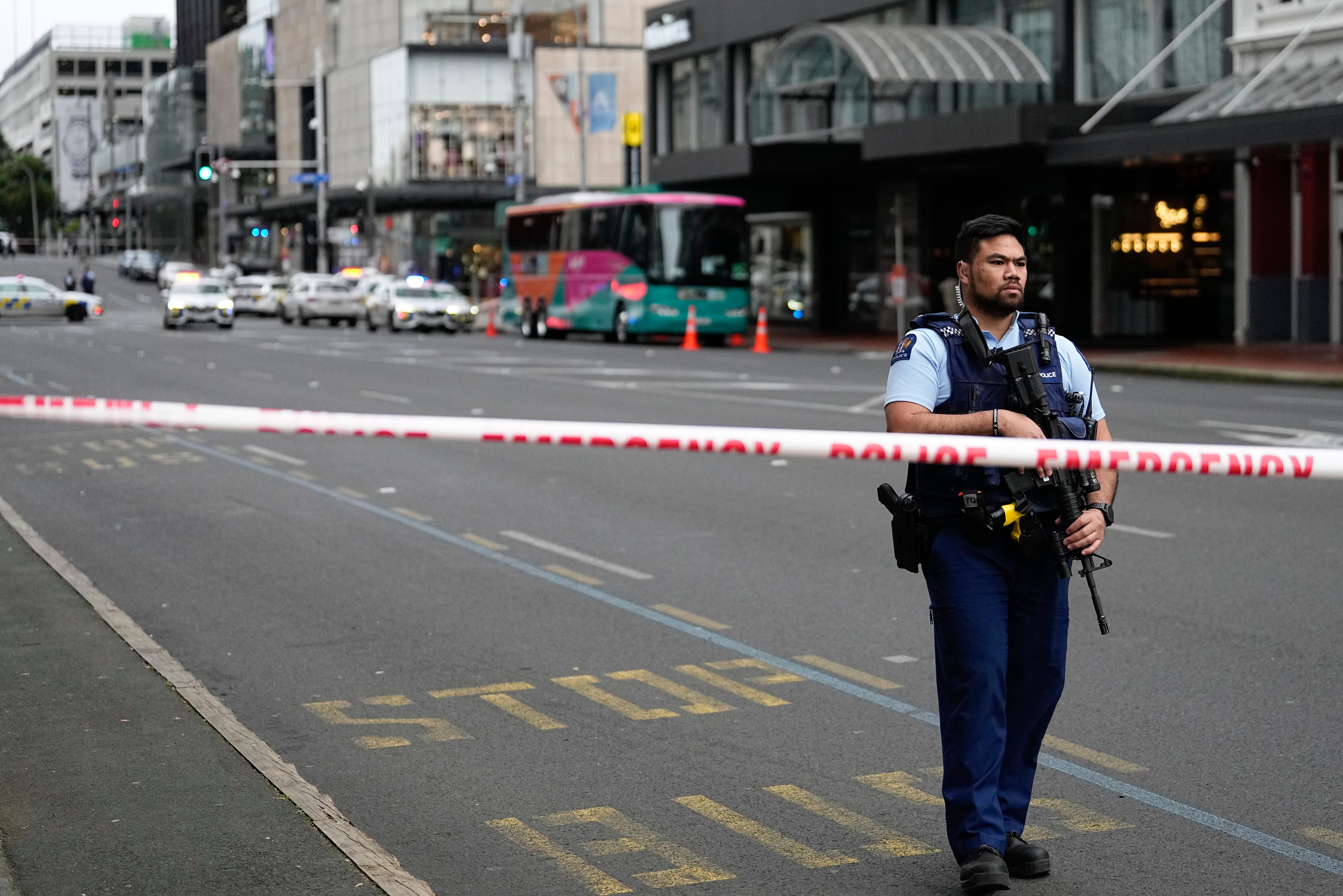 <p>Police officer stands at road block at entrance to business district in Auckland, New Zealand following shooting</p>