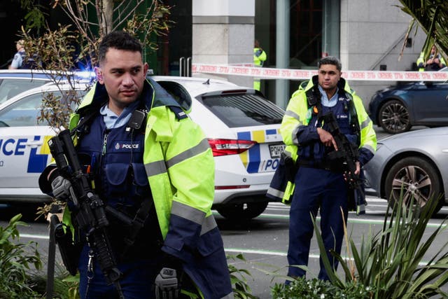 <p>Police stand guard near a construction site following a shooting in Auckland, New Zealand, on 20 July 2023</p>