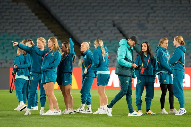 Australia’s head coach Tony Gustavsson (fourth right) walks around Stadium Australia with his players ahead of their opening World Cup finals fixture (Rick Rycroft/AP/PA)