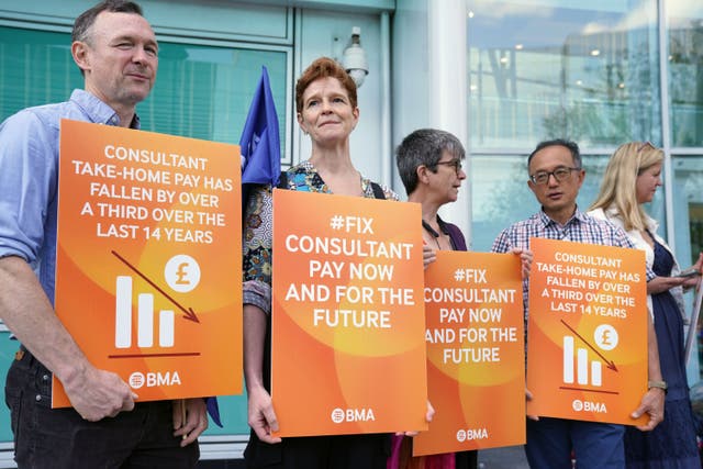 Consultant members of the British Medical Association stand on the picket line outside University College London hospital (PA)