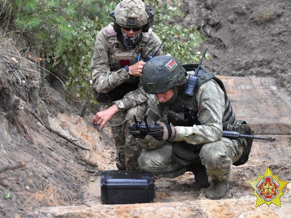 A fighter from Russian Wagner mercenary group and a Belarusian service member take part in a joint training outside Brest